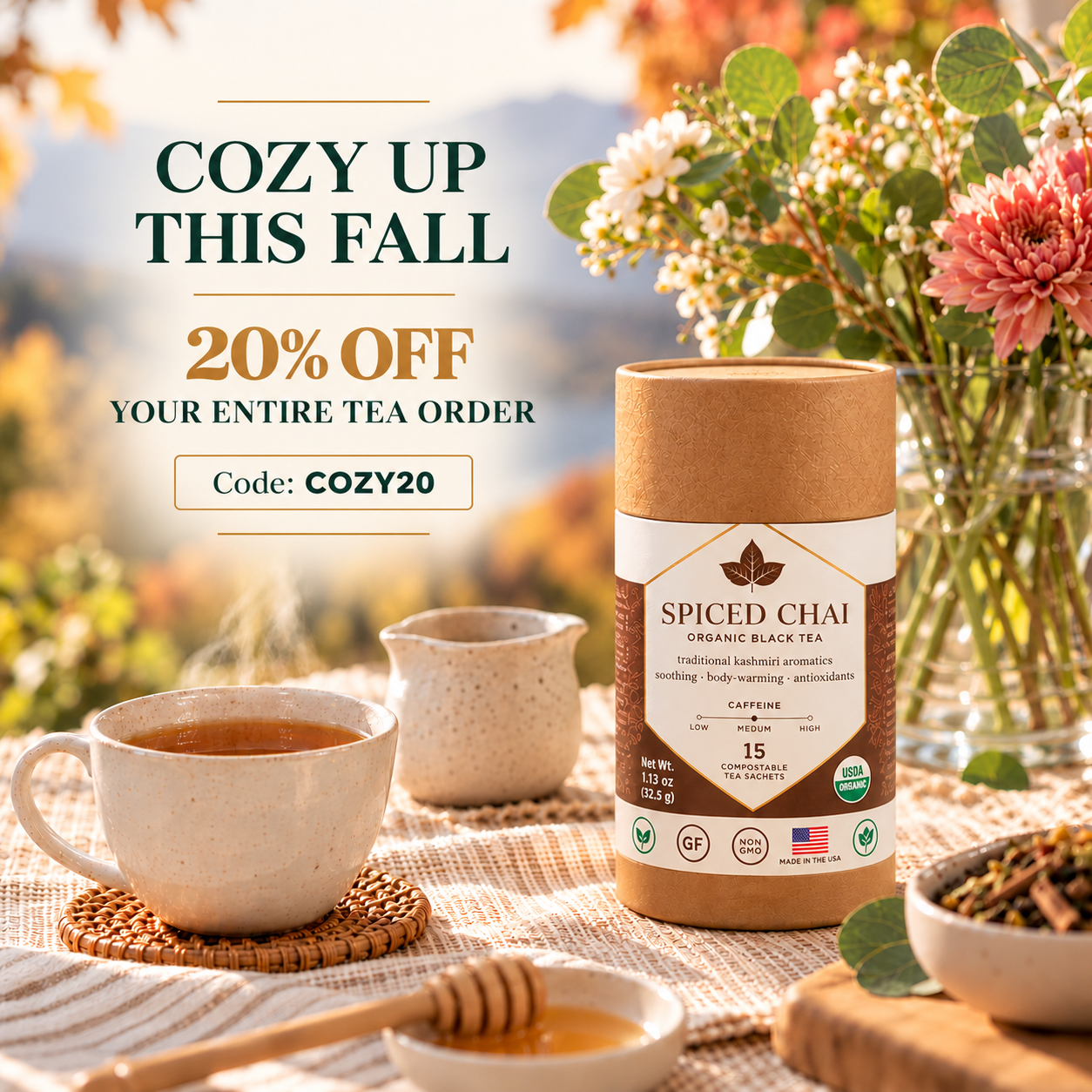 Spiced Chai organic black tea canister beside a steaming cup of tea with fall flowers and 20% off promo code COZY20