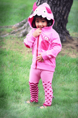 Toddler wearing pink flamingo costume hoodie with matching leggings outdoors