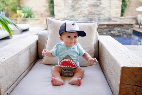 Picture of Baseball Cap, Cap, Hat, Person, Sitting, Cushion, Baby, People, Portrait, Couch
