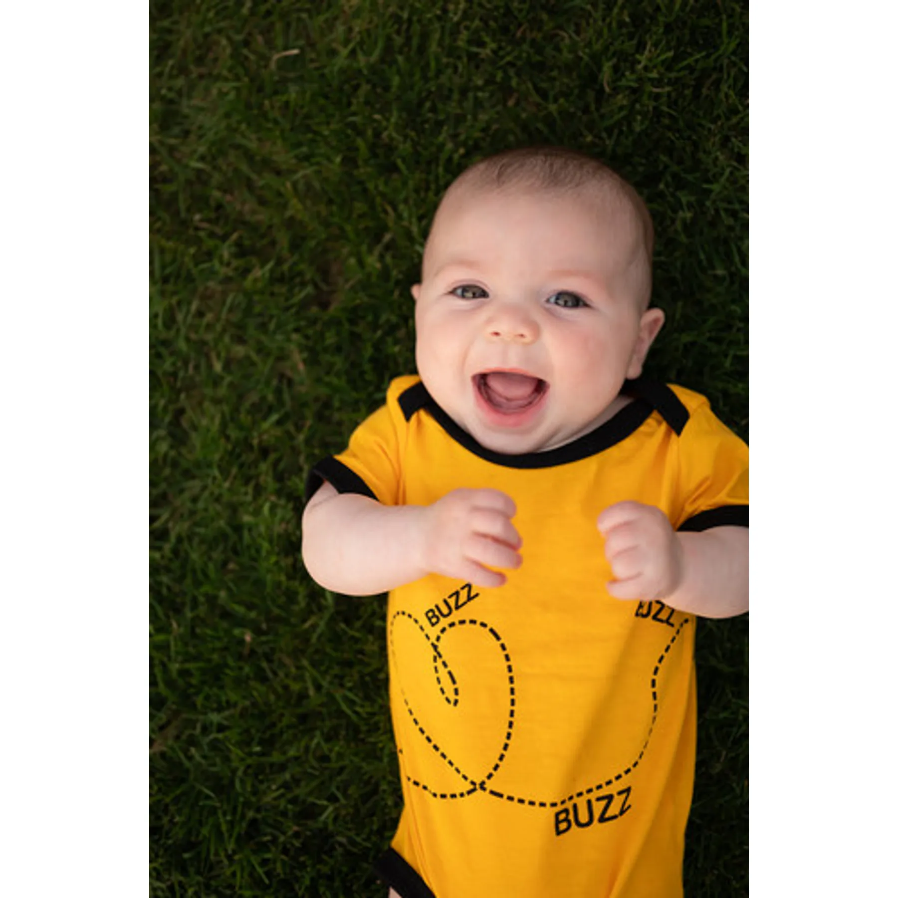Baby smiling in the Buzz the Bee bodysuit