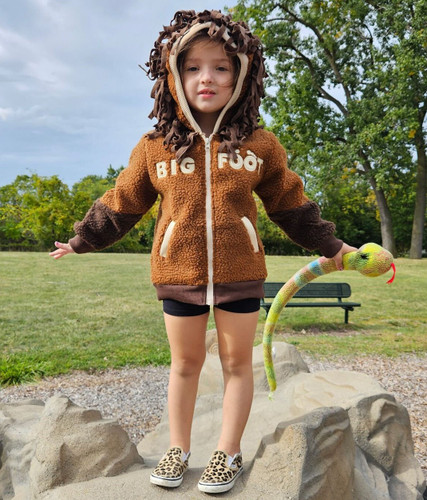 Picture of Child, Female, Girl, Person, Curly Hair, Hair, Grass, Sweater with text BIG FOOT BIG FOOT...
