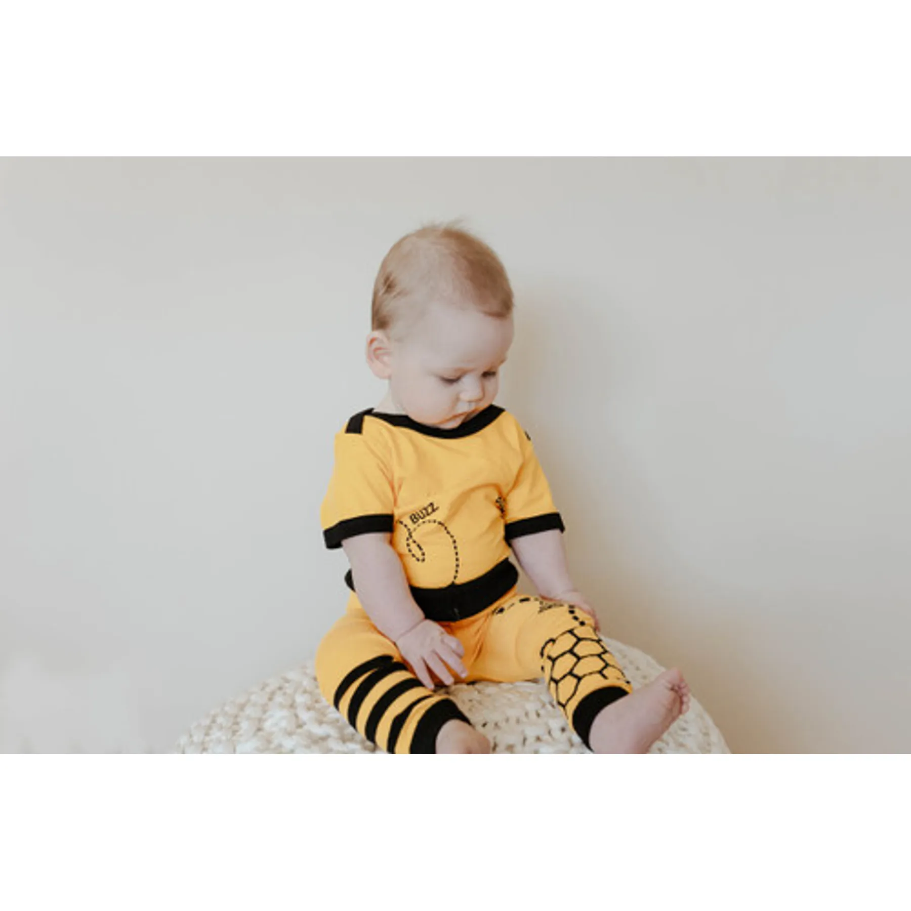 Baby sitting in Buzz the Bee outfit