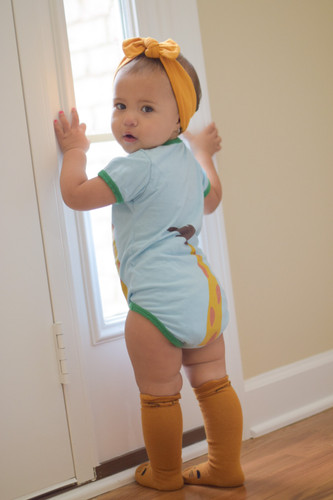 Picture of Costume, Person, Floor, Flooring, Photography, Portrait, Baby, Shorts, Shoe, Wood