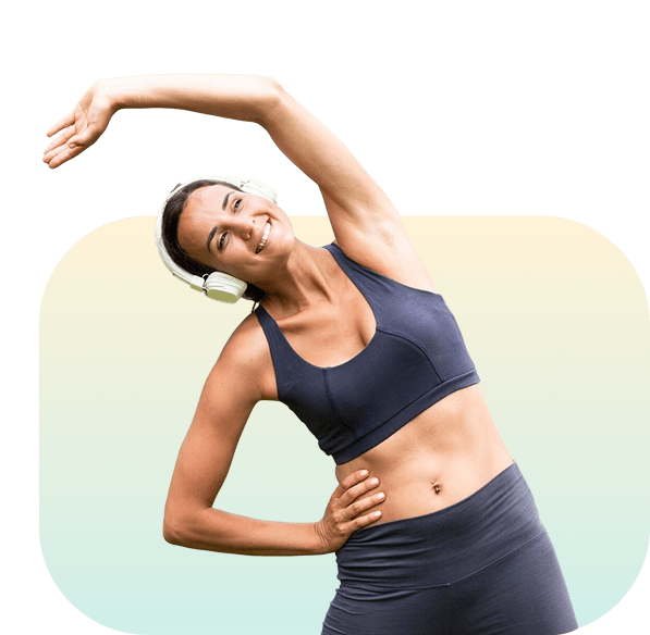 Woman doing side stretch exercise in athletic wear with headphones