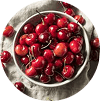 Fresh tart cherries in a bowl, overhead view, circular crop