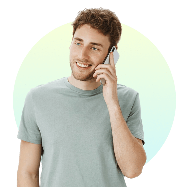 Smiling man talking on smartphone in casual t-shirt