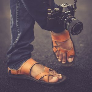 Picture of Footwear, Sandal, Photography, Camera, Person with text 8 COSINA.