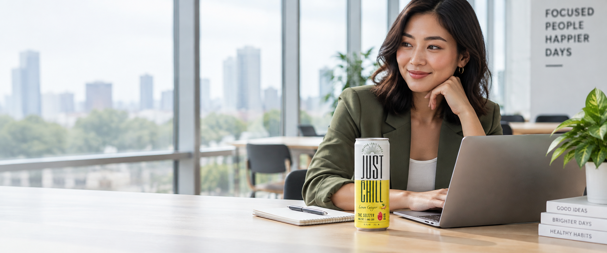 Woman working at a desk with a Just Chill Lemon Ginger THC seltzer nearby
