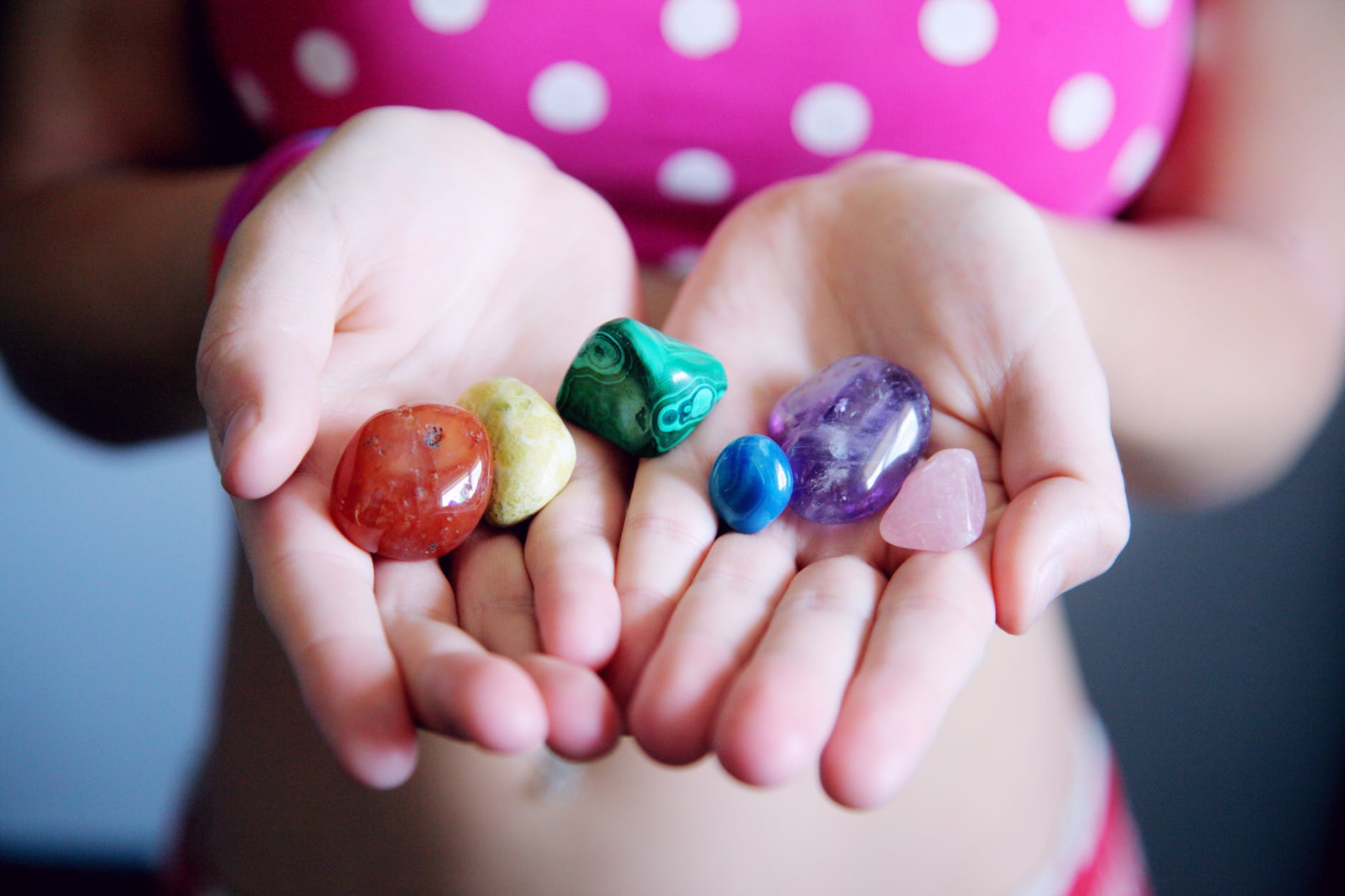 girl holding gemstone beads