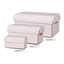 Three white corrugated boxes of different sizes with handles cut out on the end s and a white lid  in place