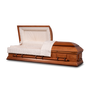 A burial wooden casket with a honey satin finish. The interior and head panel are shirred with a sunburst pattern on the inside of the head panel.
