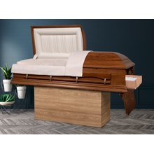 An open casket sitting on top of a corrugated stand with a beechwood print